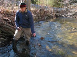 GSWA Volunteer Mike Duffy collects water quality samples from a tributary of the Upper Passaic River
